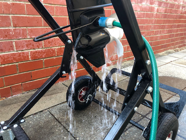 Flushing outboard motor engine while secured to a heavy duty trolley