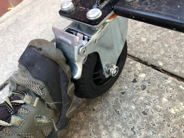 Pressing the foot brake of the outboard motor engine trolley heavy duty